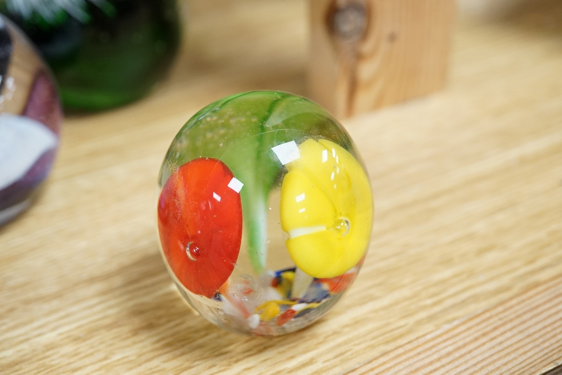 A collection of glass paperweights to include Caithness and millefiori examples, largest 10cm high